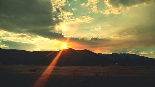 Scenic view of silhouette mountains against sky during sunset