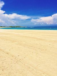 Scenic view of beach against blue sky