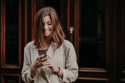 Mid adult woman using mobile phone