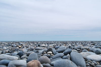 Rocks on beach against sky