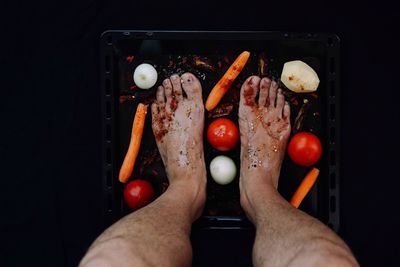 Low section of man standing on food 