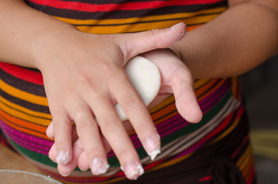 Midsection of woman holding hands