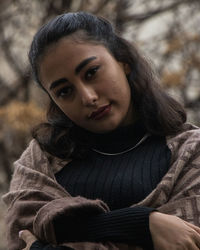 Portrait of young woman sitting outdoors