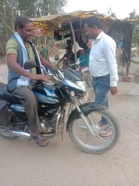 Side view of young man riding motorcycle