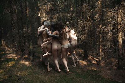 Young woman with horse in forest