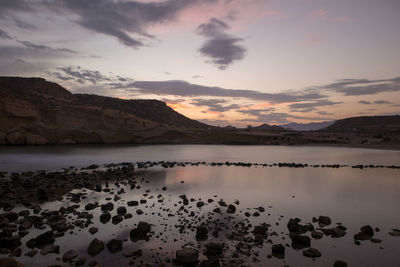 Scenic view of lake against sky during sunset