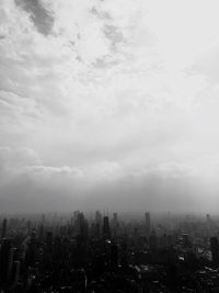 High angle view of cityscape against cloudy sky