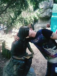 Rear view of woman sitting on bench