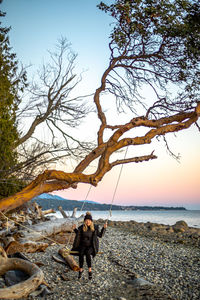 Full length of woman on beach against sky