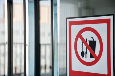 Close-up of warning sign on glass