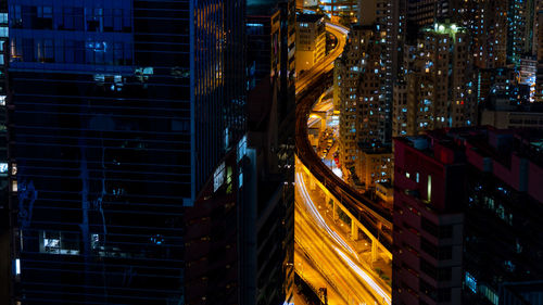 Panoramic view of city street and buildings at night