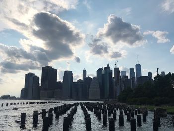 View of buildings in city against cloudy sky