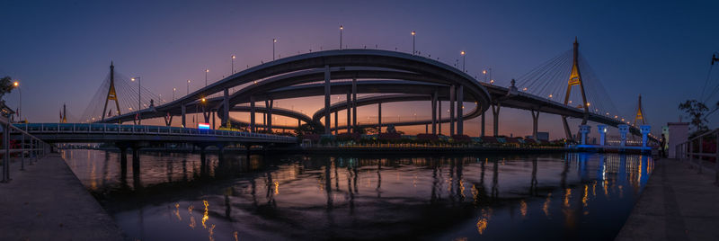 View of bridge over river at night