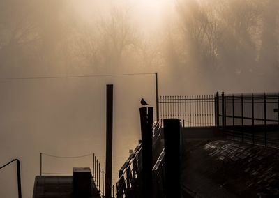 Silhouette bridge against sky during sunset