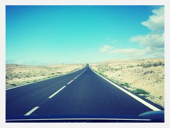 Empty road with trees in background