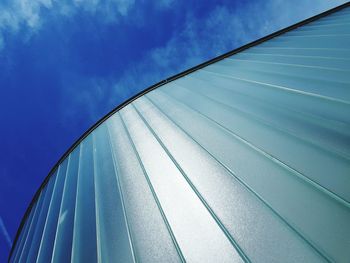 Low angle view of modern building against blue sky