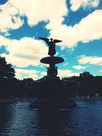 Low angle view of statue against cloudy sky