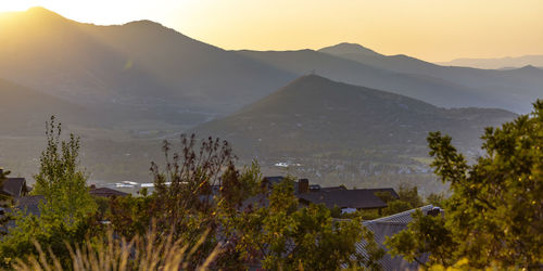 Panoramic shot of townscape by mountains against sky