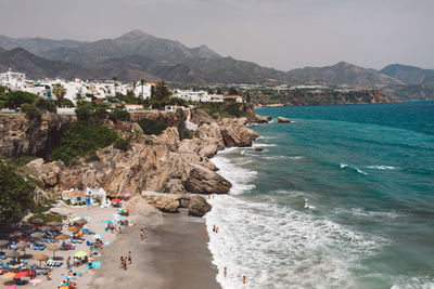 High angle view of sea and mountains against sky