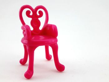 Close-up of pink toy against white background