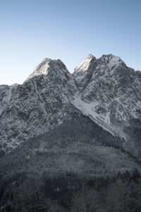 Scenic view of snowcapped mountains against clear sky