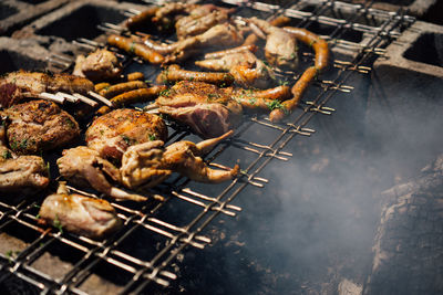 High angle view of meat on barbecue grill