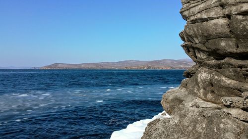 Scenic view of sea against clear blue sky