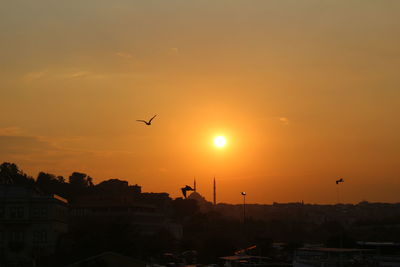 Silhouette of city at sunset