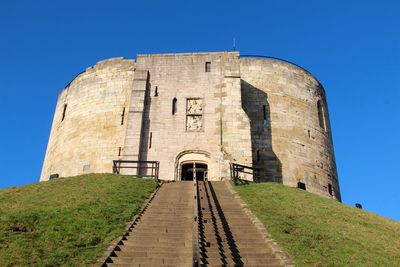 Low angle view of historical building against blue sky