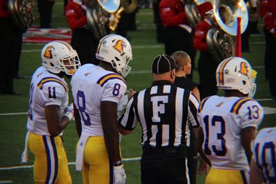 Rear view of people walking in row