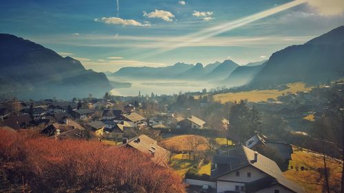 Town by mountains against sky