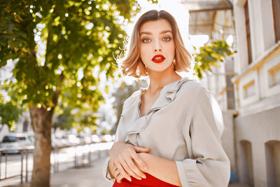 Portrait of a beautiful young woman standing outdoors