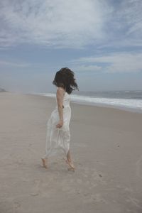 Full length of woman walking on beach