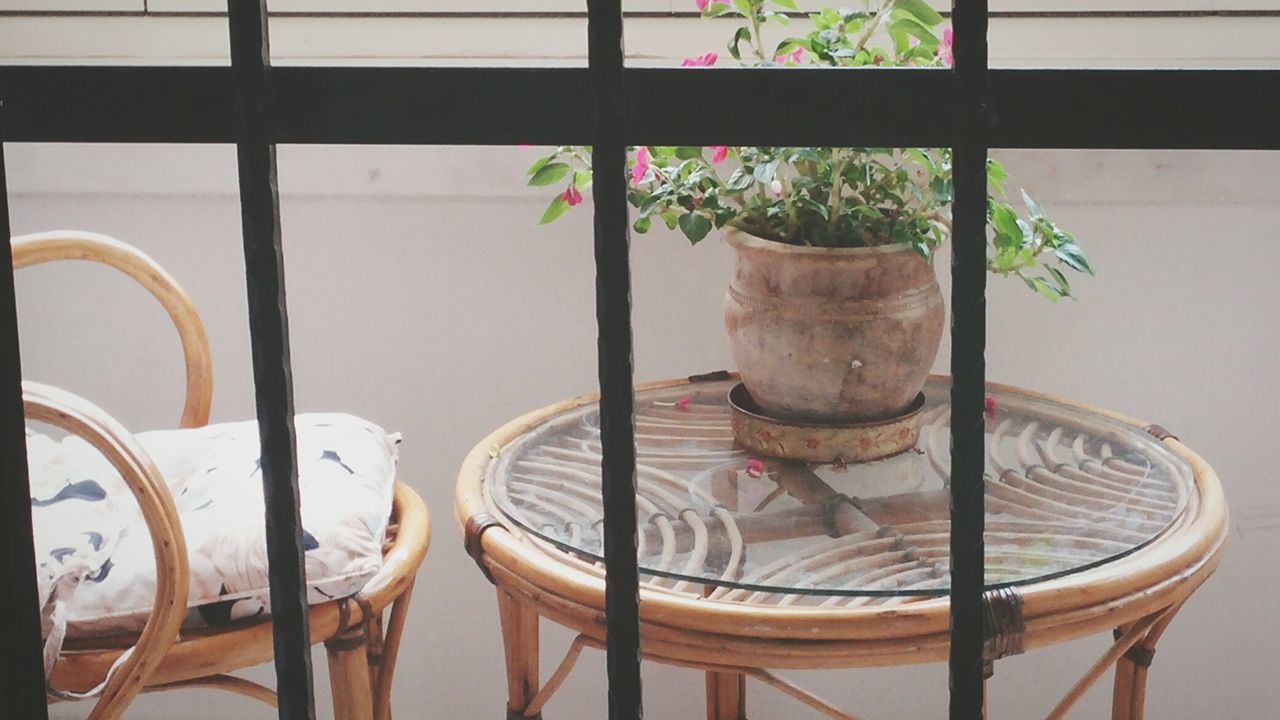 indoors, potted plant, window, chair, table, architecture, built structure, wall - building feature, plant, glass - material, home interior, vase, no people, flower pot, wall, day, absence, house, sunlight, window sill