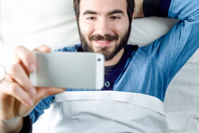 Portrait of young man using mobile phone