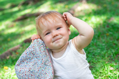 Lifestyle portrait of cute baby girl in white clothing and panama. 