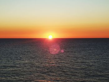 Scenic view of sea against romantic sky at sunset