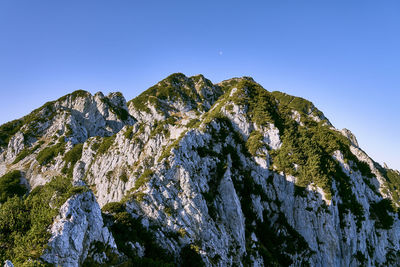 Low angle view of mountain against clear blue sky