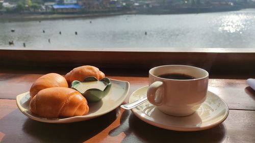 Coffee and breakfast on table