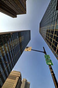 Low angle view of road sign against sky