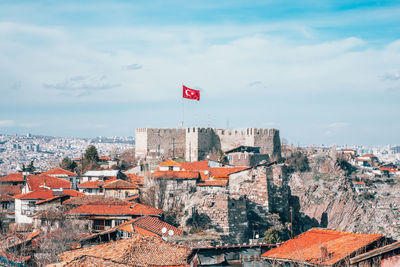 Ankara castle and other buildings in city against sky