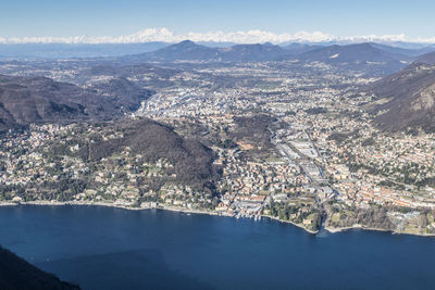 Aerial view of city and mountains against sky