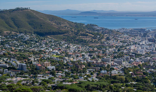 High angle view of townscape by sea against sky