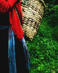 Close-up of red wicker basket on field