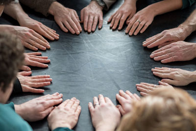 Cropped hand in circle on table