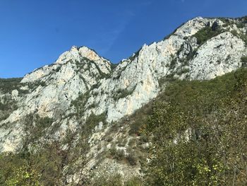 Low angle view of rocky mountains against clear sky