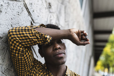 Portrait of young man holding outdoors