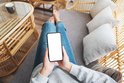 Midsection of woman using mobile phone