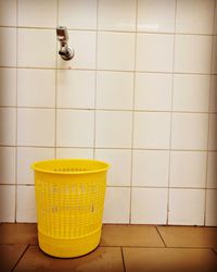 Yellow drinking glasses on tiled floor