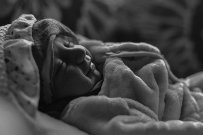 Close-up of baby sleeping on bed